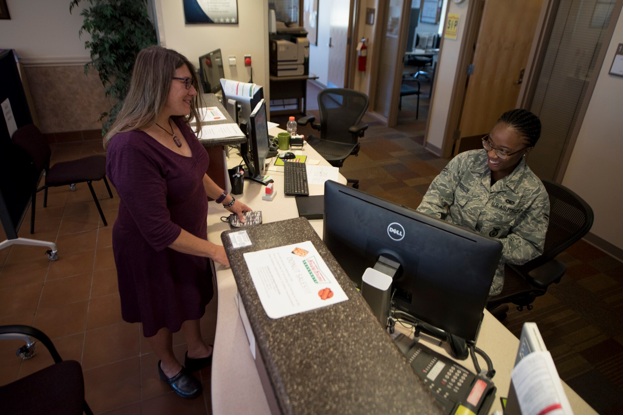 Karin Steadman receives her base access identification card at the Visitor Center on Peterson Air Force base, Colorado, Sept. 15, 2017. Through the Gold Star Base Access ID Program, Gold Star immediate family members of fallen Airmen can obtain log-term access cards to Air Force bases to access cemeteries, attend base events and receive additional services provided by the Airman & Family Readiness Center. (U.S. Air Force photo by Senior Airman Dennis Hoffman)