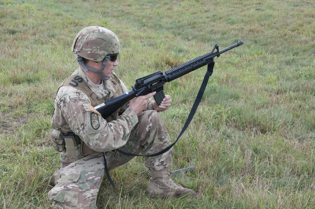 Sgt. 1st Class Martin Braden, of Meridian, Idaho, team leader and a combat engineer with the 688th Engineer Company, Harrison, Arkansas, loads and prepares to fire an M-16A2 rifle at Fort McCoy, Wisconsin.