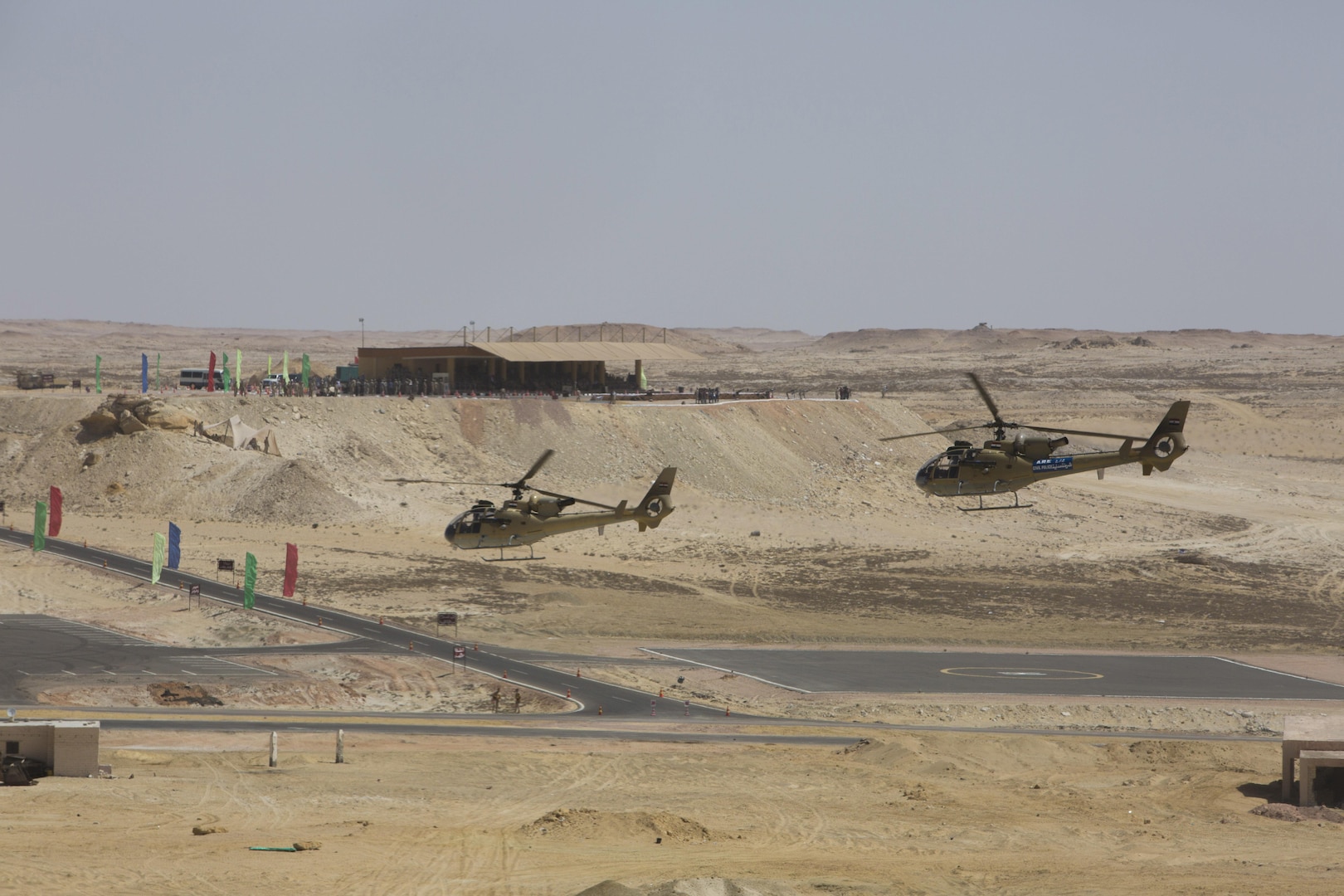 Two Egyptian Aérospatiale Gazelle helicopters fly in the foreground of a spectator veiwing area at the final combined arms live fire exercise during Bright Star 2017. Exercise Bright Star 2017 is a combined command-post and field training exercise aimed at enhancing regional security and stability by responding to modern day security scenarios with the Arab Republic of Egypt. (U.S. department of Defense photo by Tom Gagnier