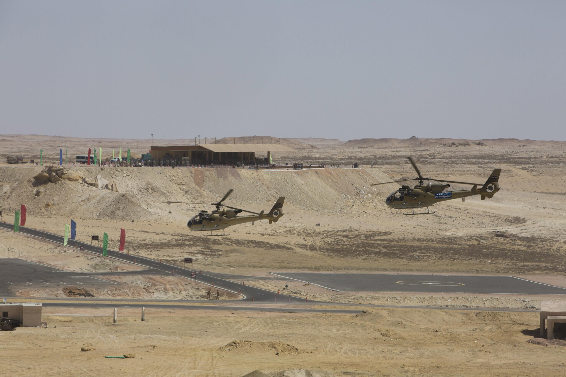 Two Egyptian Aérospatiale Gazelle helicopters fly in the foreground of a spectator veiwing area at the final combined arms live fire exercise during Bright Star 2017. Exercise Bright Star 2017 is a combined command-post and field training exercise aimed at enhancing regional security and stability by responding to modern day security scenarios with the Arab Republic of Egypt. (U.S. department of Defense photo by Tom Gagnier