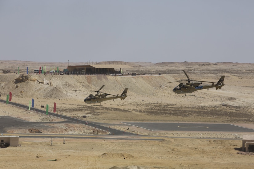 Two Egyptian Aérospatiale Gazelle helicopters fly in the foreground of a spectator veiwing area at the final combined arms live fire exercise during Bright Star 2017. Exercise Bright Star 2017 is a combined command-post and field training exercise aimed at enhancing regional security and stability by responding to modern day security scenarios with the Arab Republic of Egypt. (U.S. department of Defense photo by Tom Gagnier