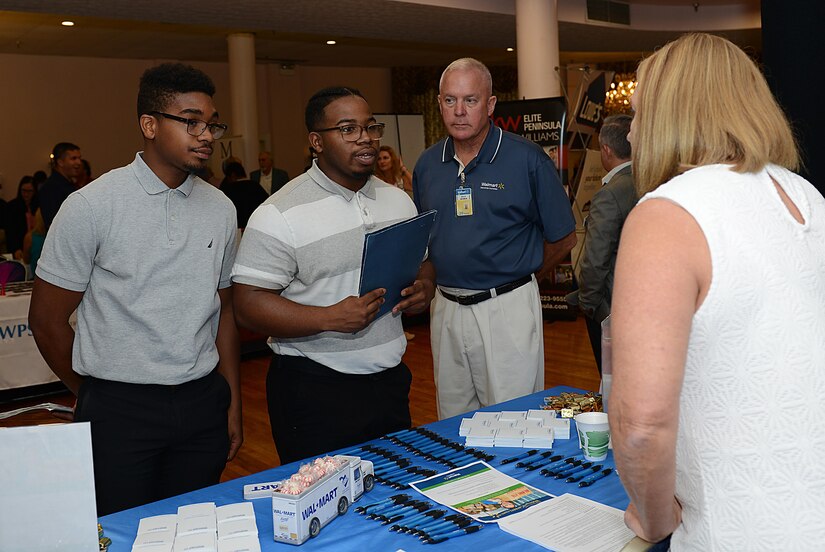 Employers speak with potential job candidates during a job fair at Joint Base Langley-Eustis, Va., Sept. 14, 2017.