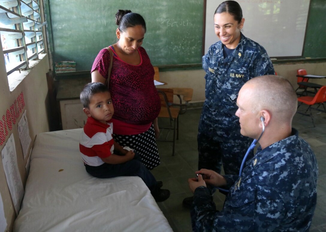 U.S. Navy medical personnel examine a boy at a local medical clinic in Honduras