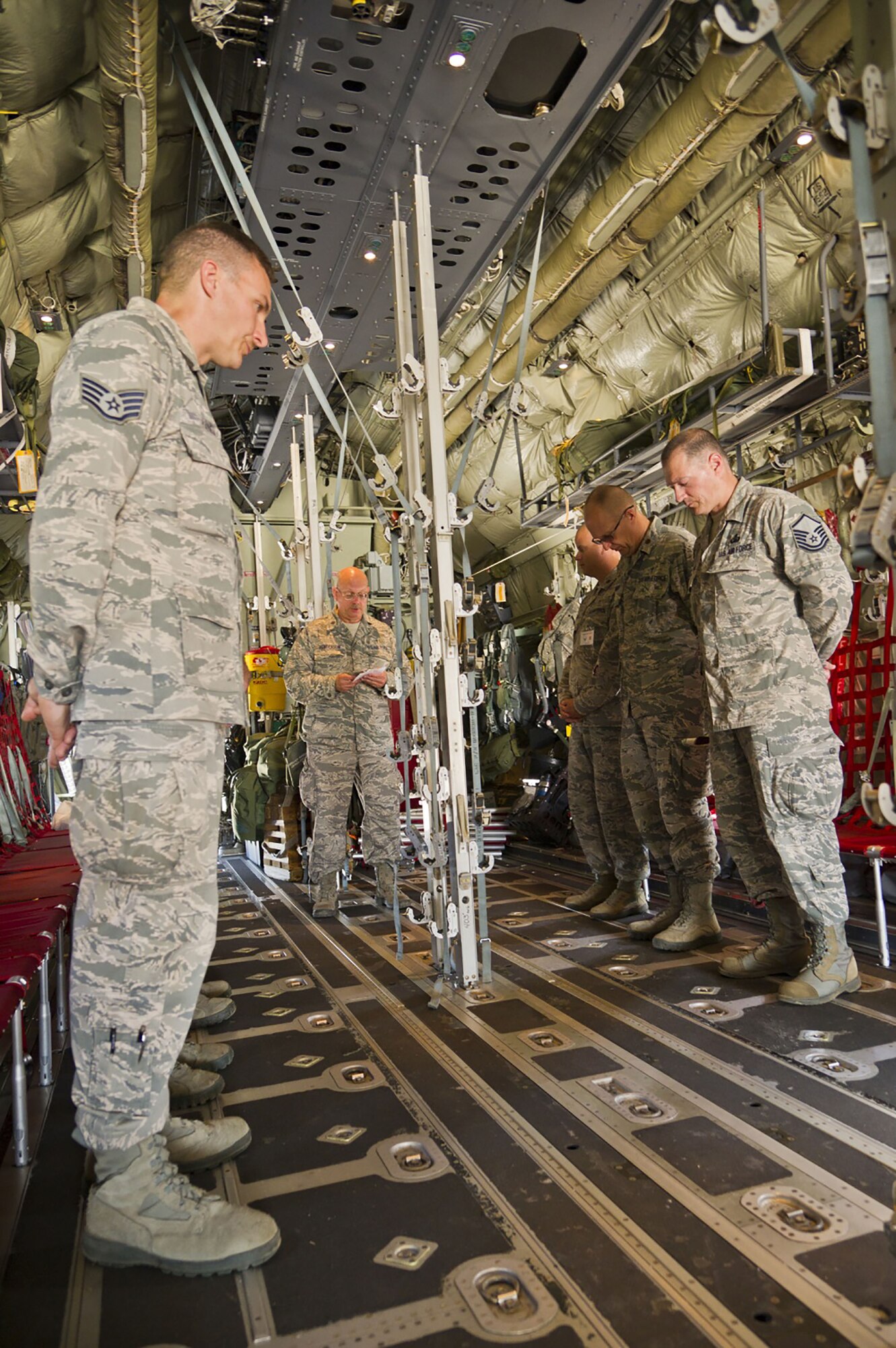(Far right) Master Sgt. Terry Reisinger, 445th Airlift Wing Chaplain Corps superintendent, chapel operations, joins fellow U.S. Air Force chaplains and their assistants as they conduct a mock dignified transfer performed by Chaplain (Lt. Col.) Larry Henderson, 307th Bomb Wing Chaplain Corps, Barksdale Air Force Base, Louisiana, inside a 130J Super Hercules aircraft during exercise Patriot Warrior at Volk Field Air National Guard Base, Wisconsin, August 19, 2017.