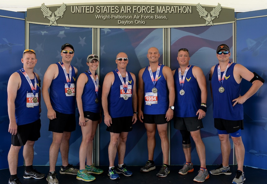 Several service members and family from Columbus Air Force Base, Mississippi pose minutes after the Air Force Marathon Sept. 16, 2017, at Wright-Patterson AFB, Ohio. The Air Force Marathon was worked by about 2,400 volunteers and had about 15,000 participants.
