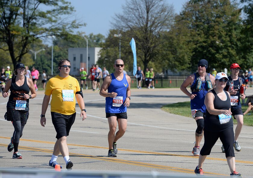 Chief Master Sgt. Tracy Tolliver (black hat), 14th Medical Group Superintendent, 1st Lt. Ricardo Torres (blue shirt), 41st Flying Training Squadron Executive Officer, and William O’Meara (blue beanie hat), Assistant Chief of Health and Safety Officer for Fire Emergency Services, run the last mile of their respective races Sept. 16, 2017, on Wright-Patterson Air Force Base, Ohio. All three members are from Columbus AFB, Mississippi. (U.S. Air Force photo by Airman 1st Class Keith Holcomb)