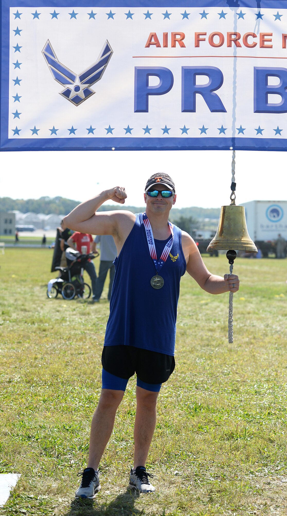 Maj. Robert Young, 43rd Flying Training Squadron instructor pilot, rings the personal record bell Sept. 16, 2017, on Wright-Patterson Air Force Base, Ohio. Young completed his first marathon and said he was happy with the accomplishment. Several members from Columbus AFB, Mississippi, made the trip to Ohio to participate in the Air Force Marathon. (U.S. Air Force photo by Airman 1st Class Keith Holcomb)