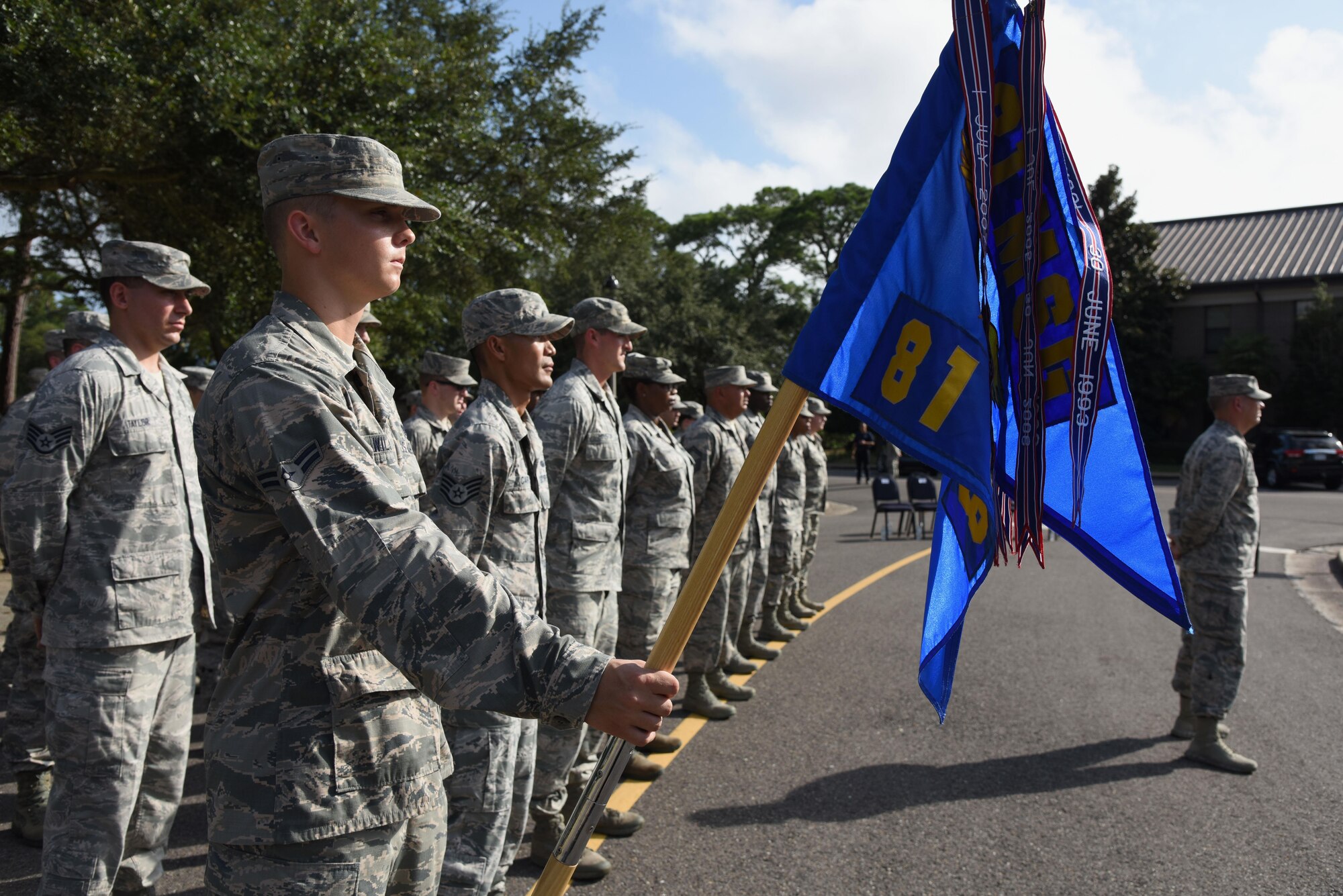 Airman 1st Class Phillip Wilson, 81st Communications Squadron client systems technician, holds the squadron guidon flag during the POW/MIA Retreat Ceremony Sept. 15, 2017, on Keesler Air Force Base, Mississippi. The event, hosted by the Air Force Sergeants Association Chapter 652, was held to raise awareness and pay tribute to all prisoners of war and military members still missing in action. (U.S. Air Force photo by Kemberly Groue)