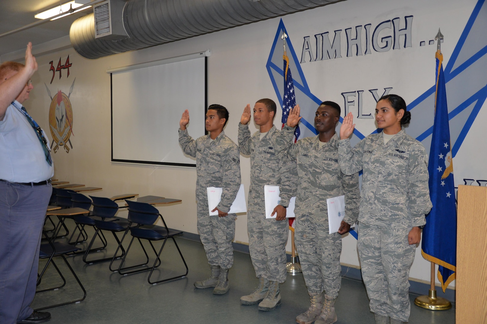 Airmen from the 344 Training Squadron display their immigration packet upon completing the Oath of Allegiance at JBSA-Lackland on Aug. 30.