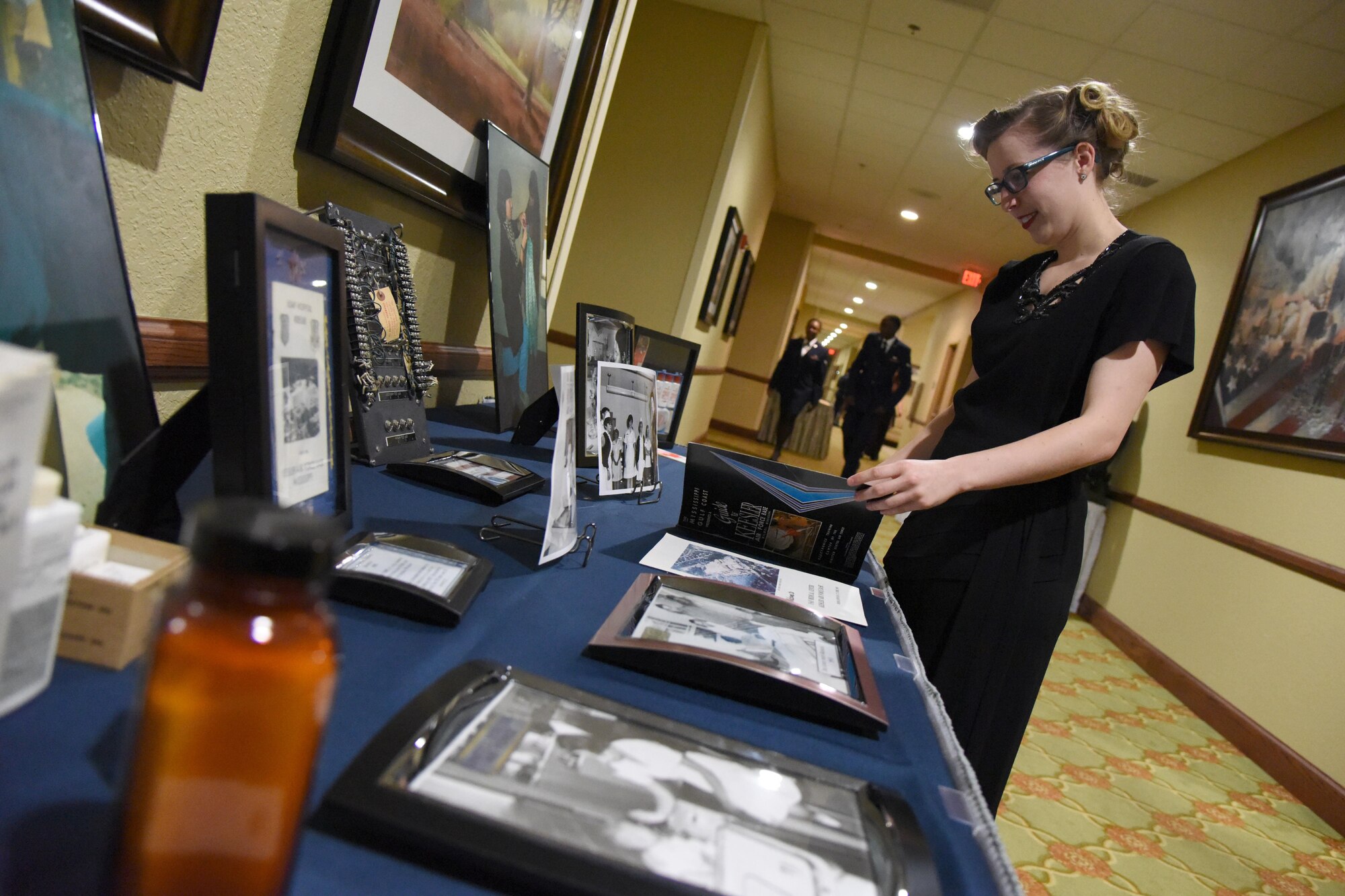 Airman 1st Class Troin Yost, 81st Medical Operations Squadron medical technician, inspects Air Force memorabilia during the U.S. Air Force 70th Birthday Ball at the Bay Breeze Event Center Sept. 16, 2017, on Keesler Air Force Base, Mississippi. The event, hosted by the 81st Training Wing and the John C. Stennis Chapter of the Air Force Association, also paid tribute to all prisoners of war and military members still missing in action. (U.S. Air Force photo by Kemberly Groue)
