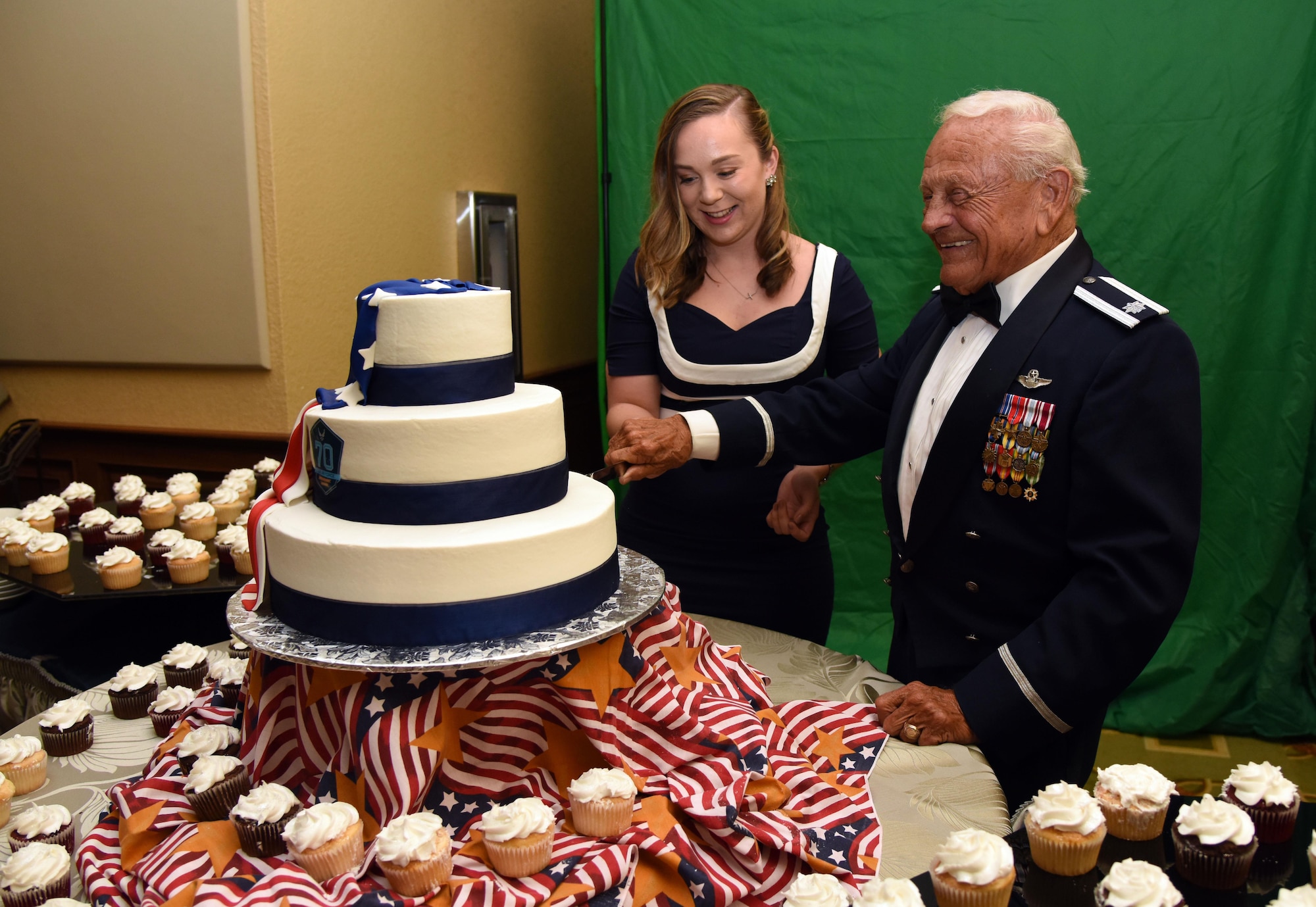 Airman Jacquelyn Gucciardi, 81st Medical Operations Squadron medical technician, and Retired Lt. Col. Dick Wilson, participate in a cake cutting ceremony during the U.S. Air Force 70th Birthday Ball at the Bay Breeze Event Center Sept. 16, 2017, on Keesler Air Force Base, Mississippi. The event, hosted by the 81st Training Wing and the John C. Stennis Chapter of the Air Force Association, also paid tribute to all prisoners of war and military members still missing in action. (U.S. Air Force photo by Kemberly Groue)