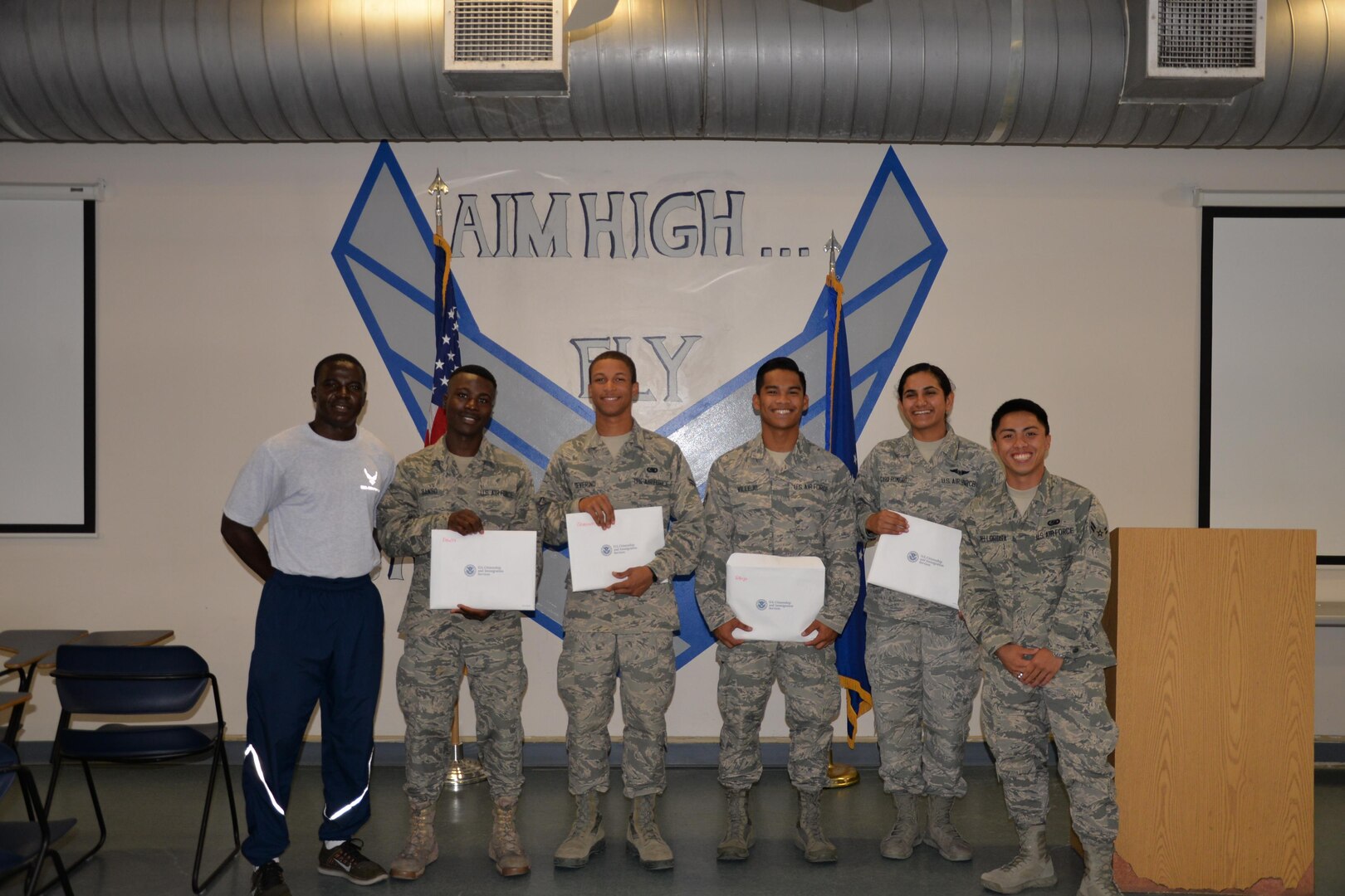 Airmen from the 344 Training Squadron display their immigration packet upon completing the Oath of Allegiance at JBSA-Lackland on Aug. 30.