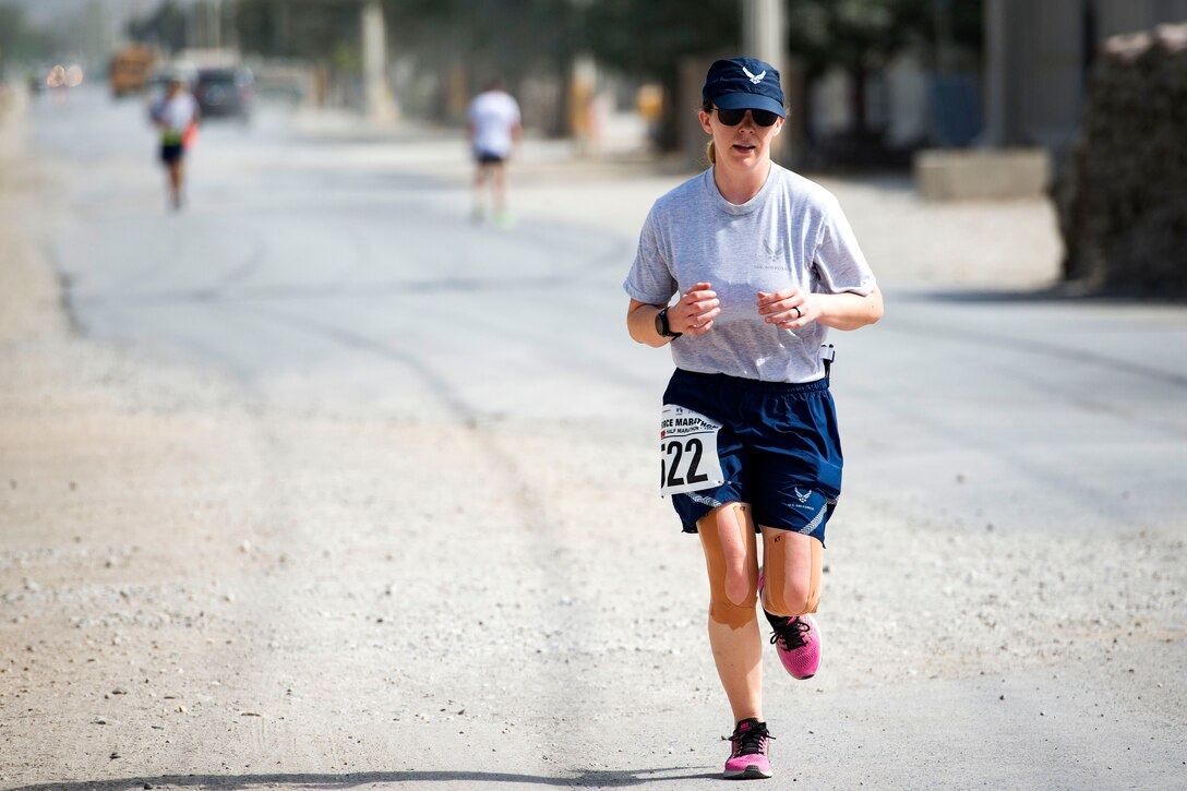 An airman runs in flat terrain.