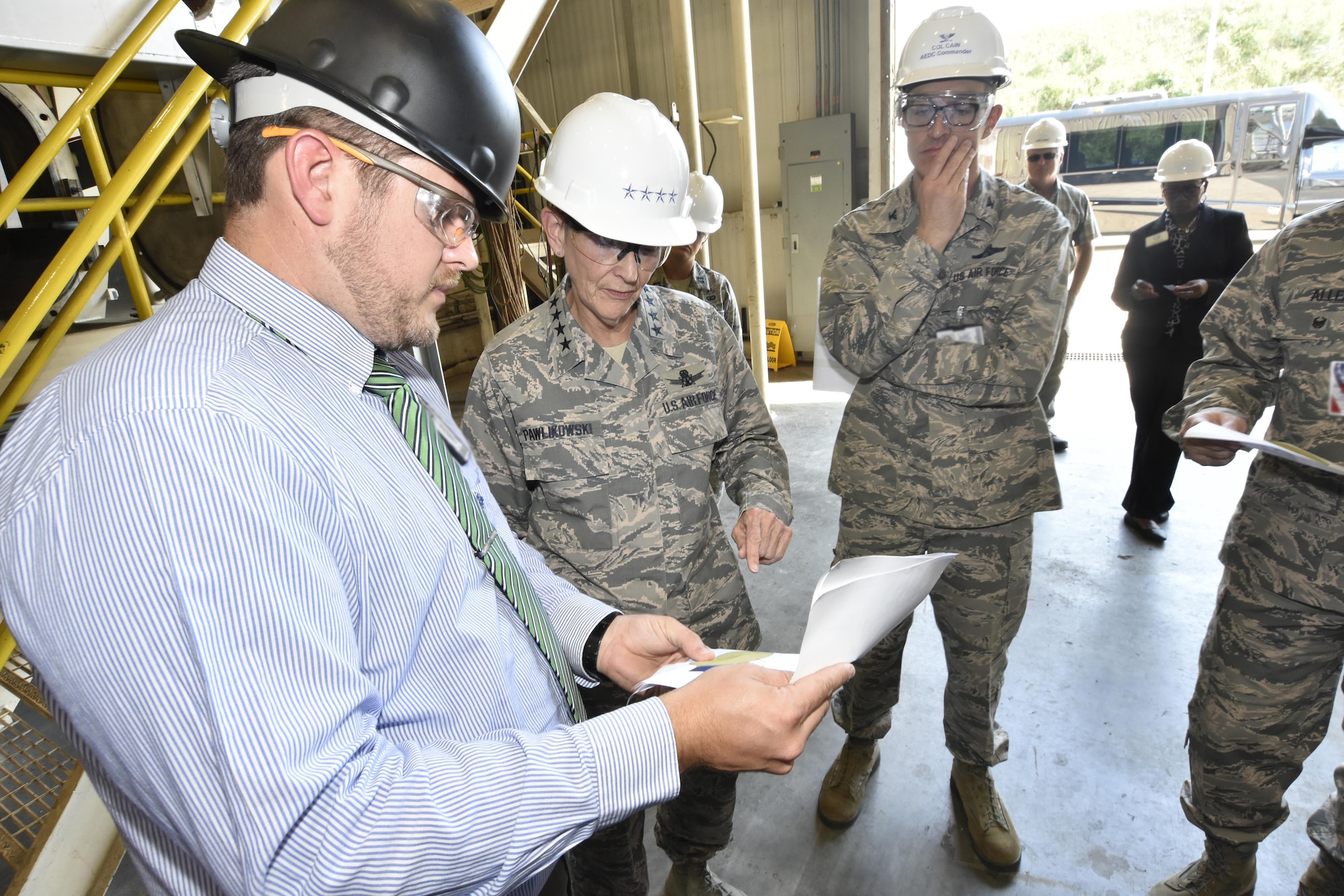 Jonathan Osborne, HTCI Project Manager and Technical Lead at Arnold Air Force Base (left) speaks with Gen. Ellen M. Pawlikowski, Air Force Materiel Command commander (center) and Col. Scott Cain, AEDC commander (right), regarding the transformation of the AEDC J-5 test facility into a facility that will support future hypersonic system weapon acquisition and research and development programs. (U.S. Air Force photo/Rick Goodfriend)