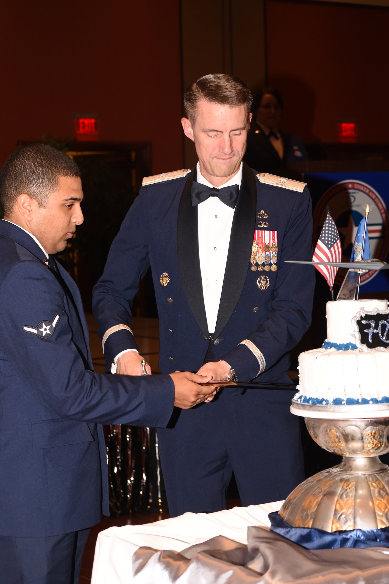 Brig. Gen. Tom Miller, commander of the Oklahoma City Air Logistics Complex, cuts the ceremonial birthday cake along with Airman William Parker from the 72nd Air Base Wing Comptroller Squadron.