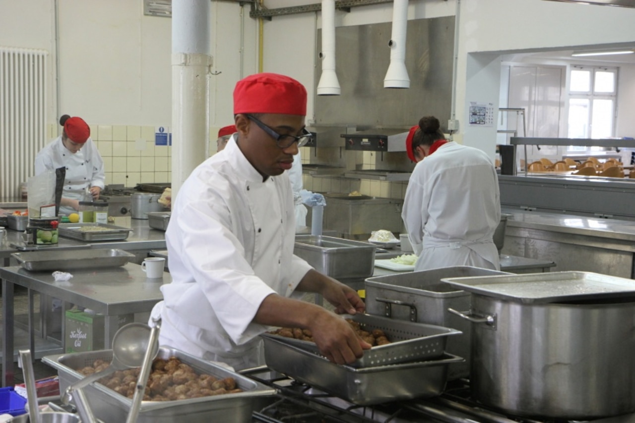 Cooks prepare food in one of the kitchens located at Sennelager Training Area, Germany.