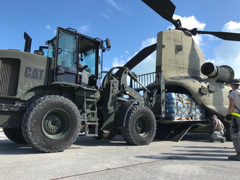 Aerial porters from the 821st Contingency Response Group, load pallets of water onto a CH-47 Chinook helicopter during Hurricane Irma relief efforts, at Marathon, Fla., Sep. 15, 2017. Due to the environment effects following the hurricane, there was a limited supply of potable water, food, and access to power. With support from the local authorities, team members delivered 10,933 cases of Meals Ready to Eat and 16,917 cases of water to the local population. (U.S. Air Force photo by Master Sgt. Jason Masiclat/Released)