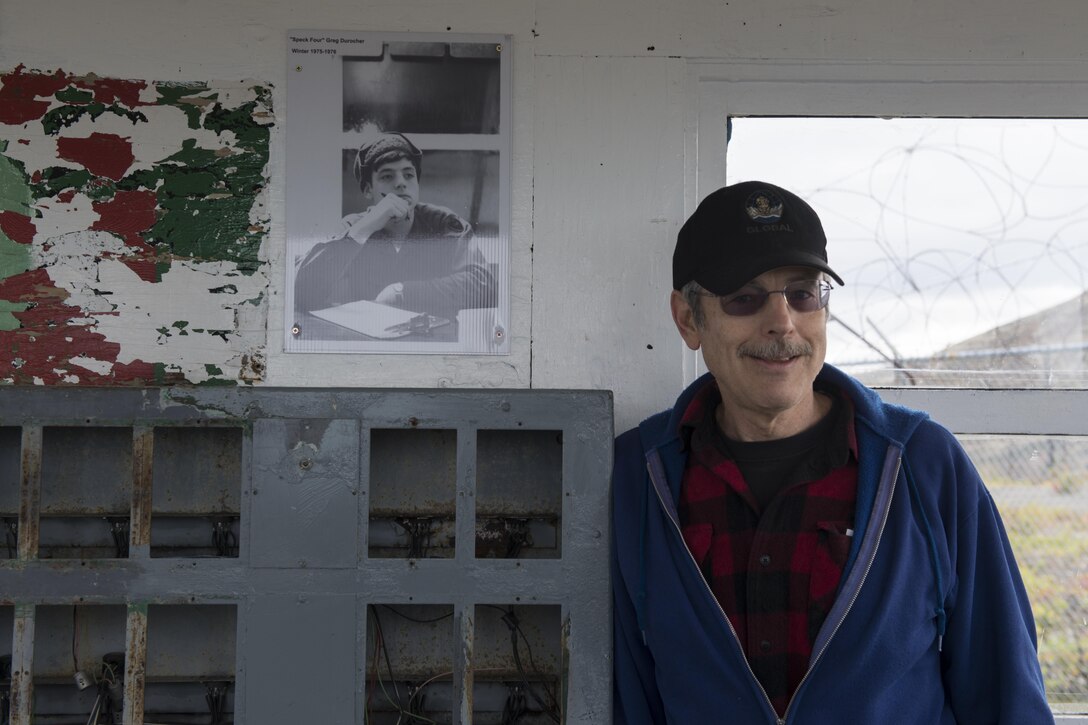 Greg Durocher, Friends of Nike Site Summit volunteer stands next to a photo of himself from the 1970s at a sentry station at Nike Site Summit, at Joint Base Elmendorf-Richardson, Alaska, Sept. 9, 2017. Nike Site Summit was constructed in 1959 as a response to the advanced Soviet bombers of the 1950s. The site was then decommissioned in 1979.