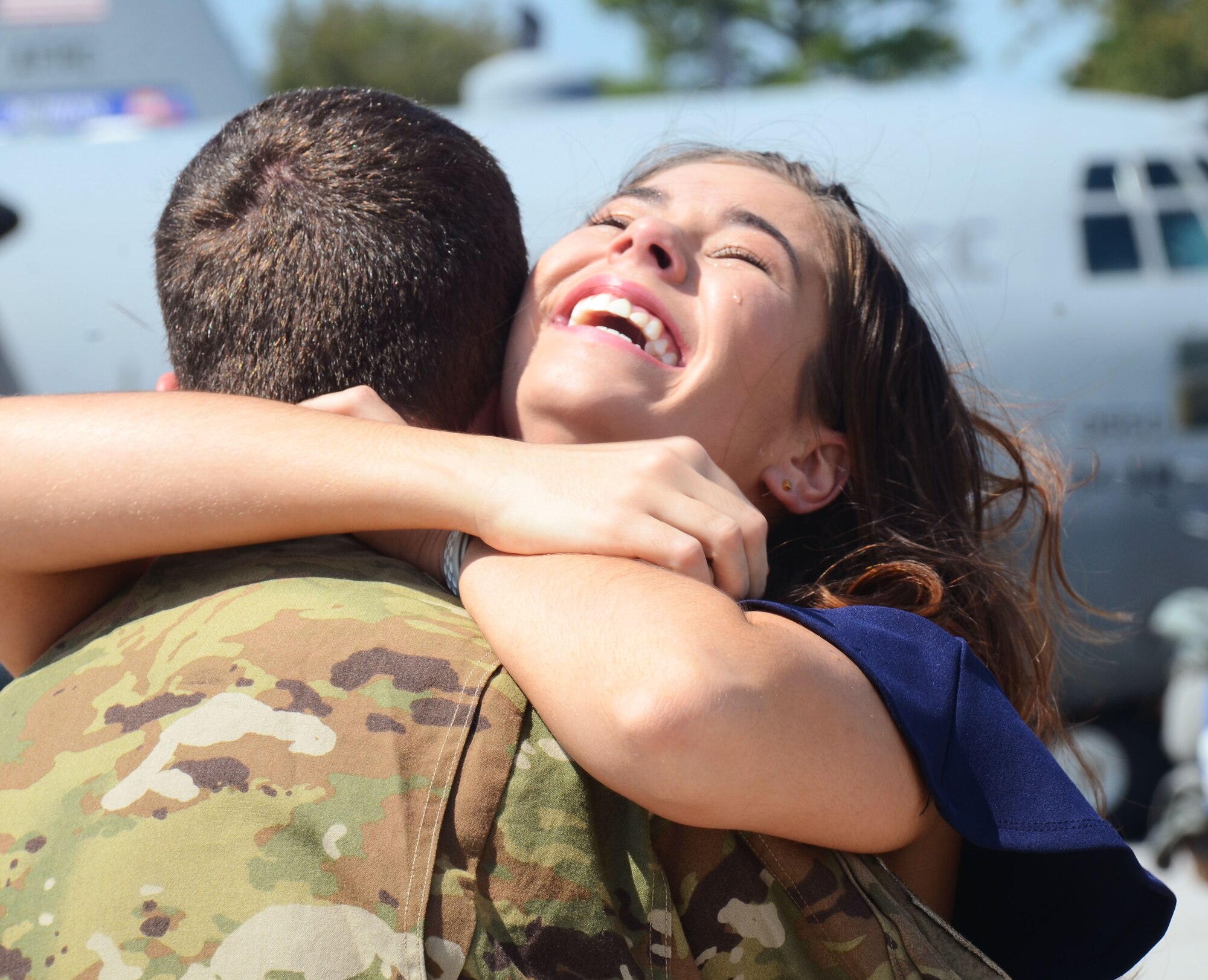 A woman embraces a returning deployer on the flightline at Dobbins Air Reserve Base, Ga. Sept. 18, 2017. Aircrews and aircraft maintainers returned to Dobbins after a four-month deployment to the Middle East in support of contingency operations. (U.S. Air Force photo/Don Peek)