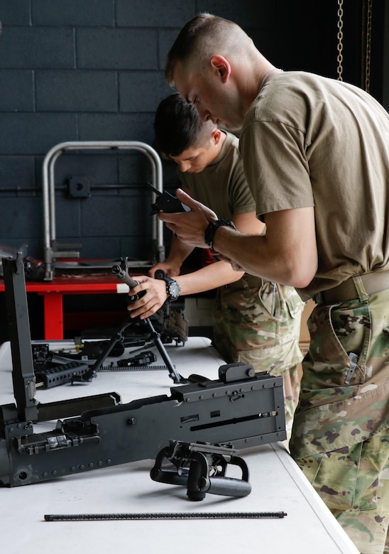 U.S. Army Soldiers assigned to the 558th Transportation Company, 10th Transportation Battalion, 7th Transportation Brigade (Expeditionary) disassemble and reassemble weapons during the company’s first “Maintenance Rodeo” competition at Third Port, Joint Base Langley-Eustis, Va., Sept. 19, 2017.