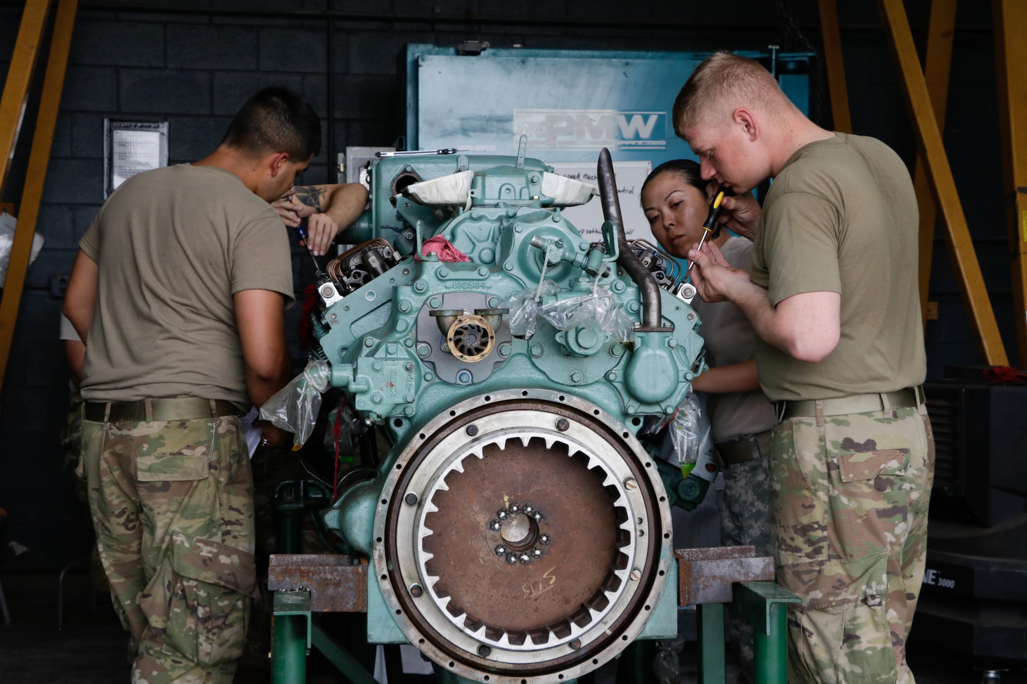 U.S. Army Soldiers assigned to the 558th Transportation Company, 10th Transportation Battalion, 7th Transportation Brigade (Expeditionary) adjust the governor and fuel injector rack on a Detroit Diesel 12V-71 watercraft engine during the company’s first “Maintenance Rodeo” competition at Third Port, Joint Base Langley-Eustis, Va., Sept. 19, 2017.