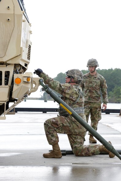 U.S. Army Soldiers from 558th Transportation Company, 10th Transportation Battalion, 7th Transportation Brigade (Expeditionary) perform vehicle recovery actions in two Light Medium Tactical Vehicles during the company’s first “Maintenance Rodeo” competition at Third Port, Joint Base Langley-Eustis, Va., Sept. 19, 2017.