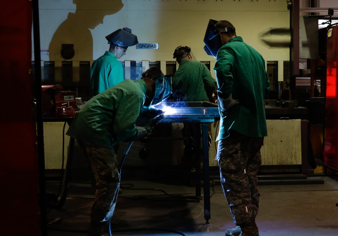 U.S. Army Soldiers from the 558th Transportation Company, 10th Transportation Battalion, 7th Transportation Brigade (Expeditionary) conduct welding operations and fabricate an outdoor bench during the company’s first “Maintenance Rodeo” competition at Third Port, Joint Base Langley-Eustis, Va., Sept. 19, 2017.