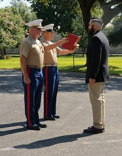 SAN ANTONIO (Sept. 8, 2017) Command Sgt. Maj. Max Garcia, center, 3D Assault Amphibian Battalion in Camp Pendleton, California, reads an award citation for Marine Corps veteran Corporal Randy D. Mann, right, while Lt. Col. William O'Brien, commanding officer stands at attention during a ceremony in the historical quadrangle at Joint Base San Antonio - Fort Sam Houston, Texas. Mann was awarded the Navy and Marine Corps Medal during the ceremony in his hometown of San Antonio for his actions while on active duty with the 3D Assault Amphibian Battalion in July 2013. (U.S. Navy photo by Mass Communication Specialist 1st Class Jacquelyn D. Childs/Released)