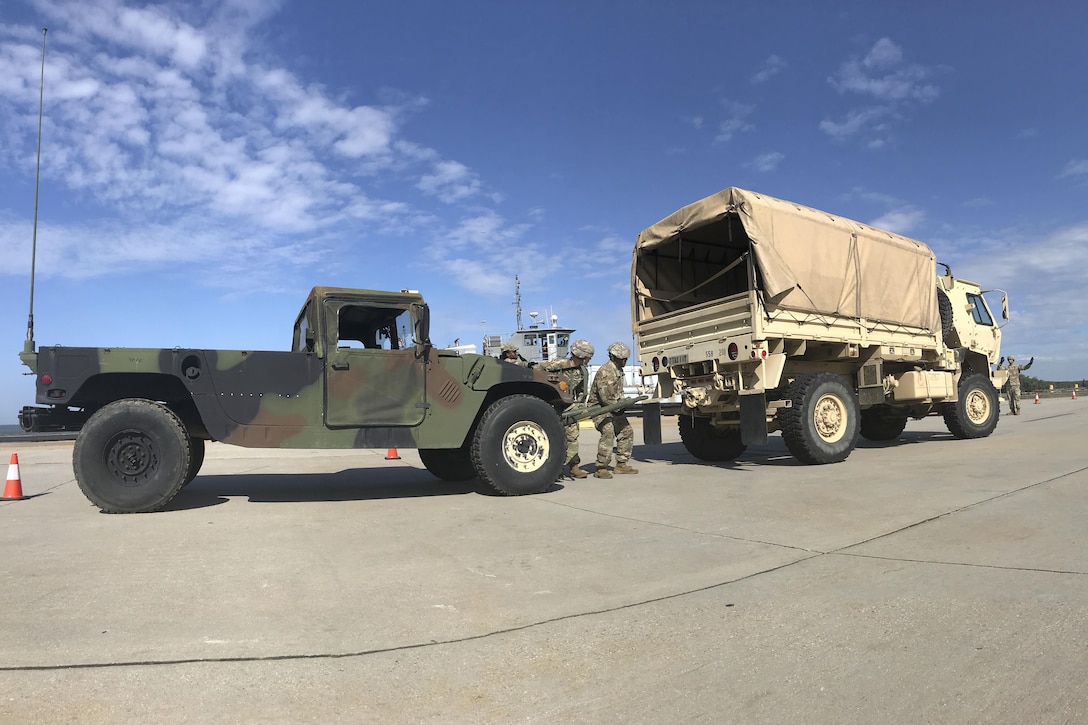 U.S. Army Soldiers assigned to the 558th Transportation Company, 10th Transportation Battalion, 7th Transportation Brigade (Expeditionary)  prepare to hook up a HUMVEE to a Light Medium Tactical Vehicle at the vehicle recovery station during the company’s first “Maintenance Rodeo” competition at Third Port, Joint Base Langley-Eustis, Va., Sept. 20, 2017.