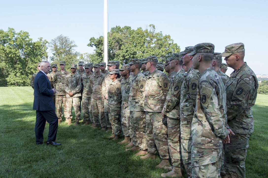 Defense Secretary Jim Mattis stands facing a group of soldiers.