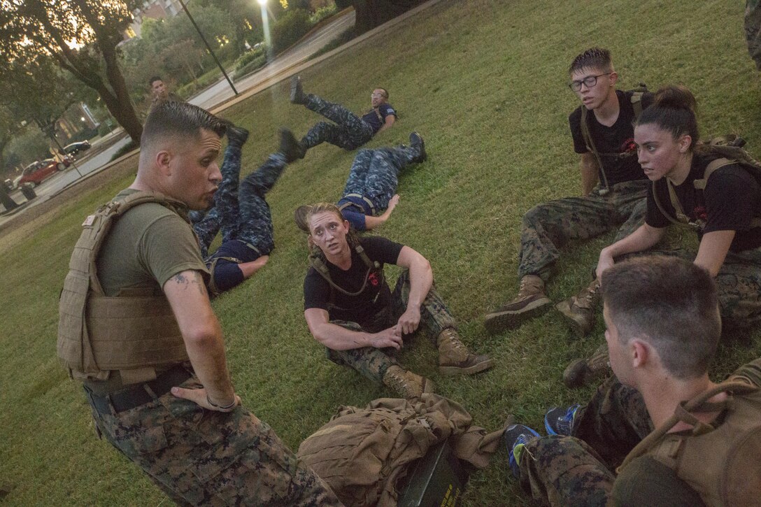 Marine Corps Sgt. Jose Gomez (left), an administrative specialist with Installation Personnel Administration Center, Headquarters Battalion, Marine Forces Reserve, talks to Naval Reserve Officers Training Corps midshipmen at Tulane University in New Orleans, Sept. 20, 2017.