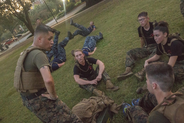 Marine Corps Sgt. Jose Gomez (left), an administrative specialist with Installation Personnel Administration Center, Headquarters Battalion, Marine Forces Reserve, talks to Naval Reserve Officers Training Corps midshipmen at Tulane University in New Orleans, Sept. 20, 2017.