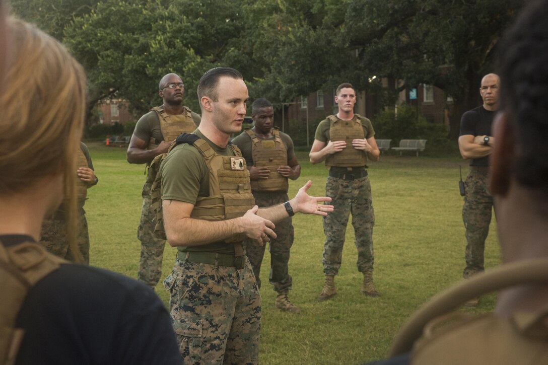 Marine Corps Sgt. Joshua Derrick, training and operations non-commissioned officer with Headquarters Battalion, Marine Forces Reserve, talks to Naval Reserve Officers Training Corps midshipmen after a morning workout at Tulane University in New Orleans, Sept. 20, 2017.