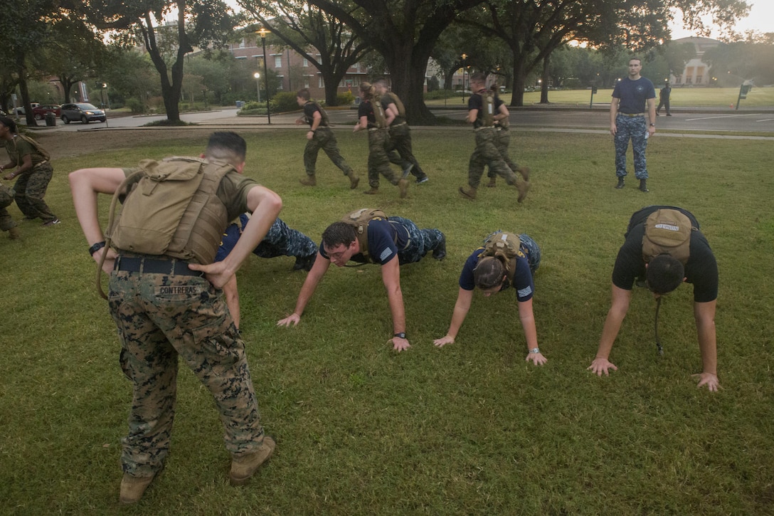 Marine Corps Cpl. Andrew Contreras, operations non-commissioned officer with Marine Light Attack Helicopter Squadron 773, Marine Aircraft Group 49, 4th Marine Aircraft Wing, Marine Forces Reserve, leads a core workout for Naval Reserve Officers Training Corps midshipmen at Tulane University in New Orleans, Sept. 20, 2017.