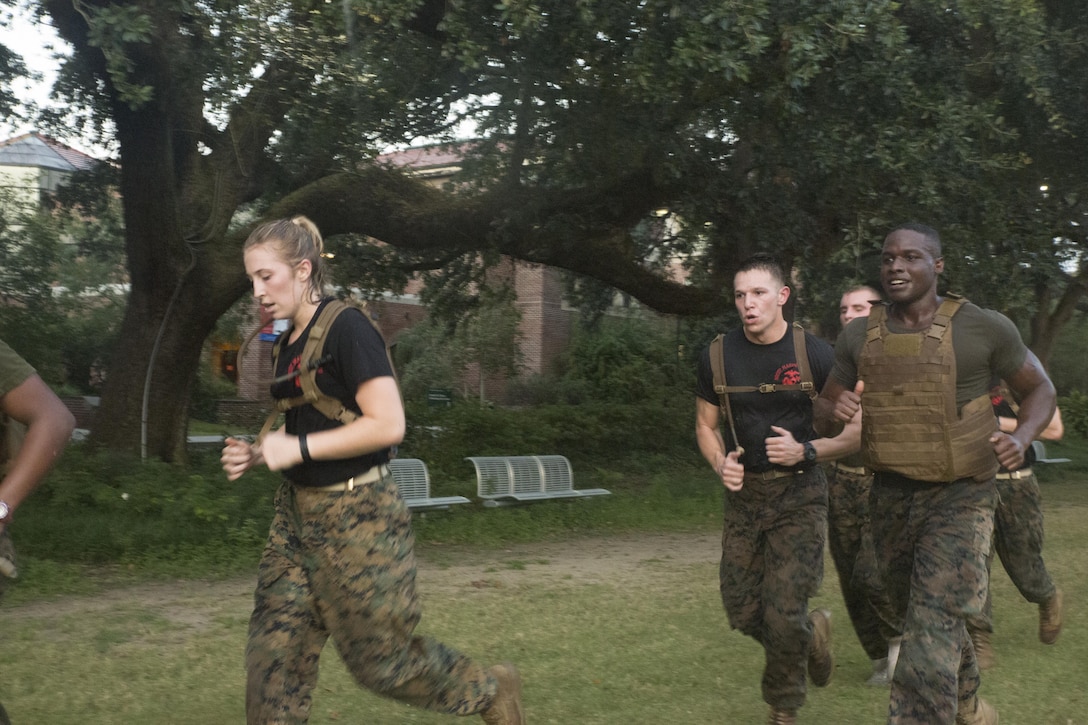 Marine Corps Cpl. Dejurne McCall (right), an administrative clerk with Installation Personnel Administration Center, Headquarters Battalion, Marine Forces Reserves, runs alongside Naval Reserve Officers Training Corps midshipmen during a morning workout at Tulane University in New Orleans, Sept. 20, 2017.