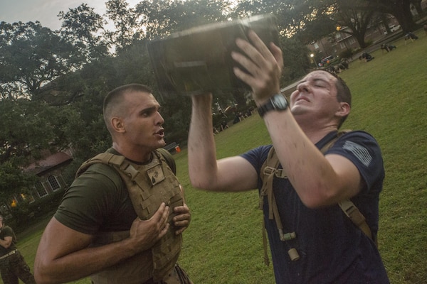 Marine Corps Sgt. Ian Ferro (left), a combat correspondent with Headquarters Battalion, Marine Forces Reserve, motivates a Naval Reserve Officers Training Corps midshipman during ammo can lifts at Tulane University in New Orleans, Sept. 20, 2017.