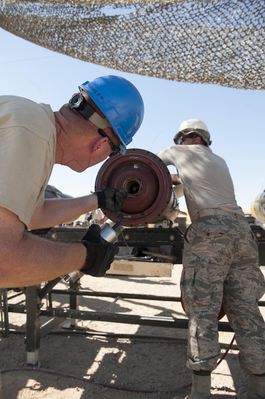 Maj. Allyn Swavely, a participant in the Senior Officer Orientation course, helps guide an electrical fuse into position during a day of hands on training for the SOO course at Beale Air Force Base, California, Aug. 30, 2017. Mechanical and electrical fuses are among a few of the types of fuses utilized in the bombs and are initially powered by the airflow of the falling weapon system. (U.S. Air Force photo/Senior Airman Justin Parsons)