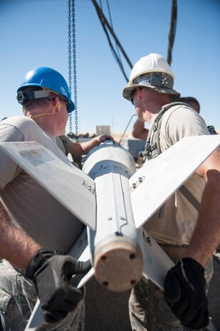 U.S. Air Force senior leaders hold the fin of a MK-84 bomb in position as it is attached to the main body during a orientation course at Beale Air Force Base, California Aug. 30, 2017. The orientation course is a two day hands on display of the rigors of bomb building. (U.S. Air Force photo/Senior Airman)