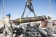 Maj. Allyn Swavely, a participant in the Senior Officer Orientation course, helps guide the body of a MK-84 onto the Munitions Assembly Conveyor at Beale Air Force Base, California, Aug. 30, 2017. Bombs built by munitions Airmen can range in weight up to approximately 2,000 lbs and have multiple configurations depending on operational demands. (U.S. Air Force photo/Senior Airman Justin Parsons)