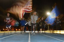 Master Sgt. Humberto Abiera, 55th Aerial Port Squadron, carries the U.S. Flag as he leads members from the 349th Air Mobility Wing during the National POW/MIA Recognition Day run Sept. 15, 2017, at Travis Air Force Base, Calif.