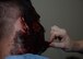 Jamie Gujski, 51st Medical Group simulation operator, applies fake blood to 51st Civil Engineer Squadron dorm leader Staff Sgt. Elliot Pearson’s face before the start of a simulated building fire during exercise Beverly Herd 17-3 at Osan Air Base, Republic of Korea September 20, 2017. Gujski makes the mock injuries by hand and gives medical personnel the chance to provide realistic care to patients to test how well they treat casualties during an emergency. (U.S. Air Force photo by Tech Sgt. Ashley Tyler)