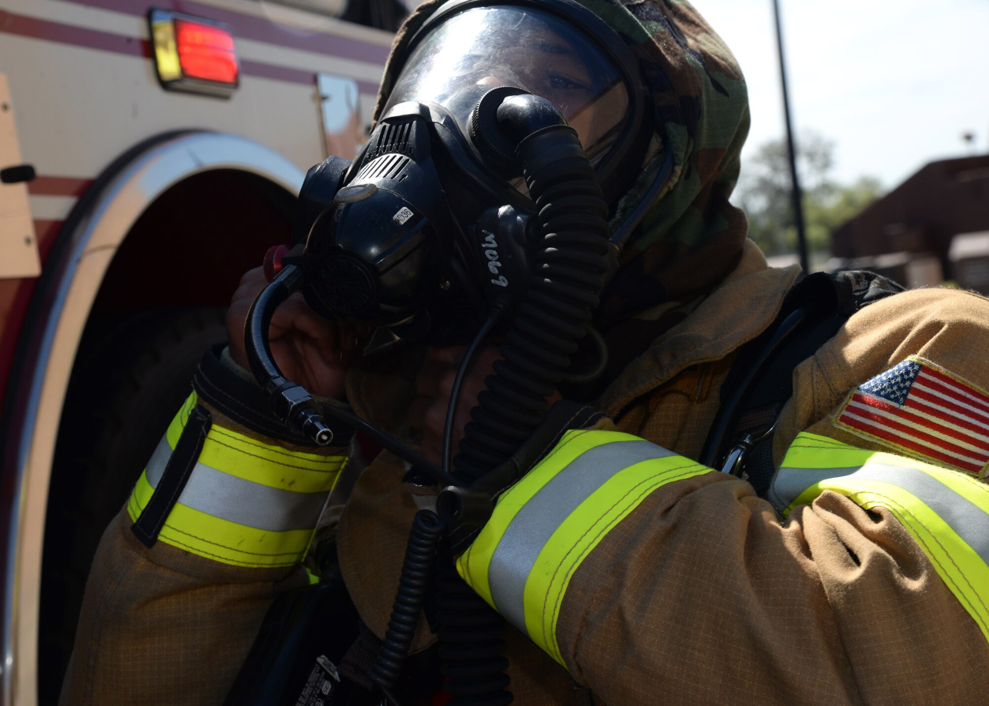 Airman Marcus Gray, 51st Civil Engineer Squadron firefighter, dons his gas mask before responding to a simulated building fire during exercise Beverly Herd 17-3 at Osan Air Base, Republic of Korea September 20, 2017. The exercise was held to evaluate how well base units provided emergency support while defending assets and personnel in a hostile chemical, biological, radiological and nuclear environment. (U.S. Air Force photo by Tech Sgt. Ashley Tyler)