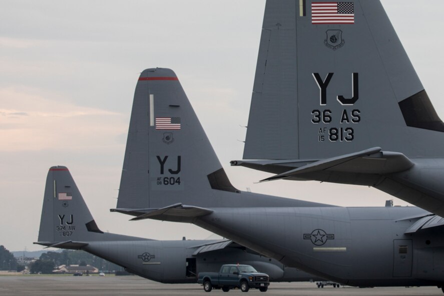 Three C-130J Super Hercules’ sit on the flightline at Yokota Air Base, Japan