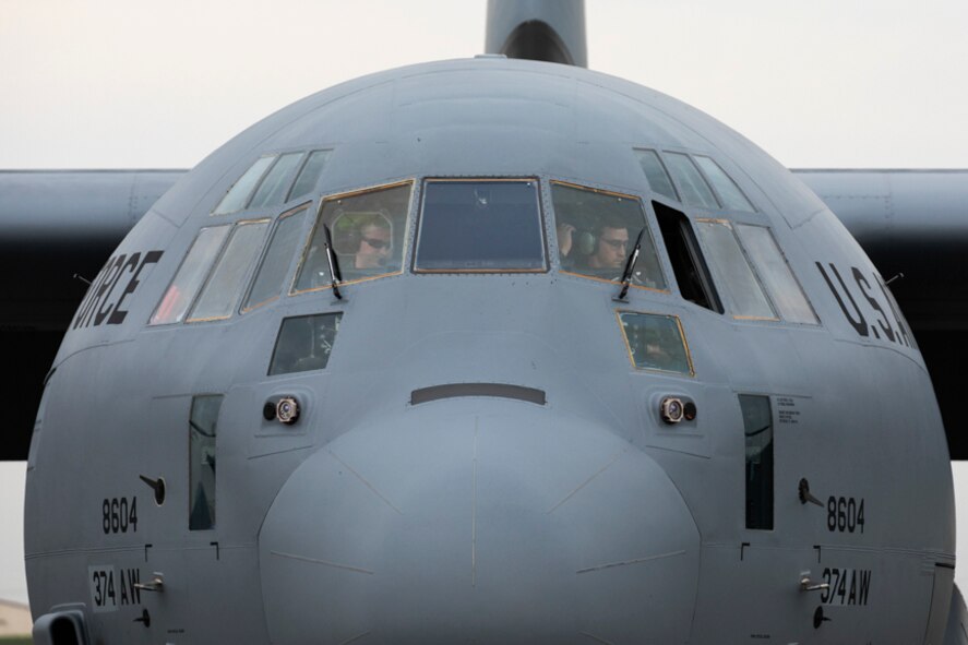Crewmembers with the 36th Airlift Squadron perform a post flight inspection after landing at Yokota
