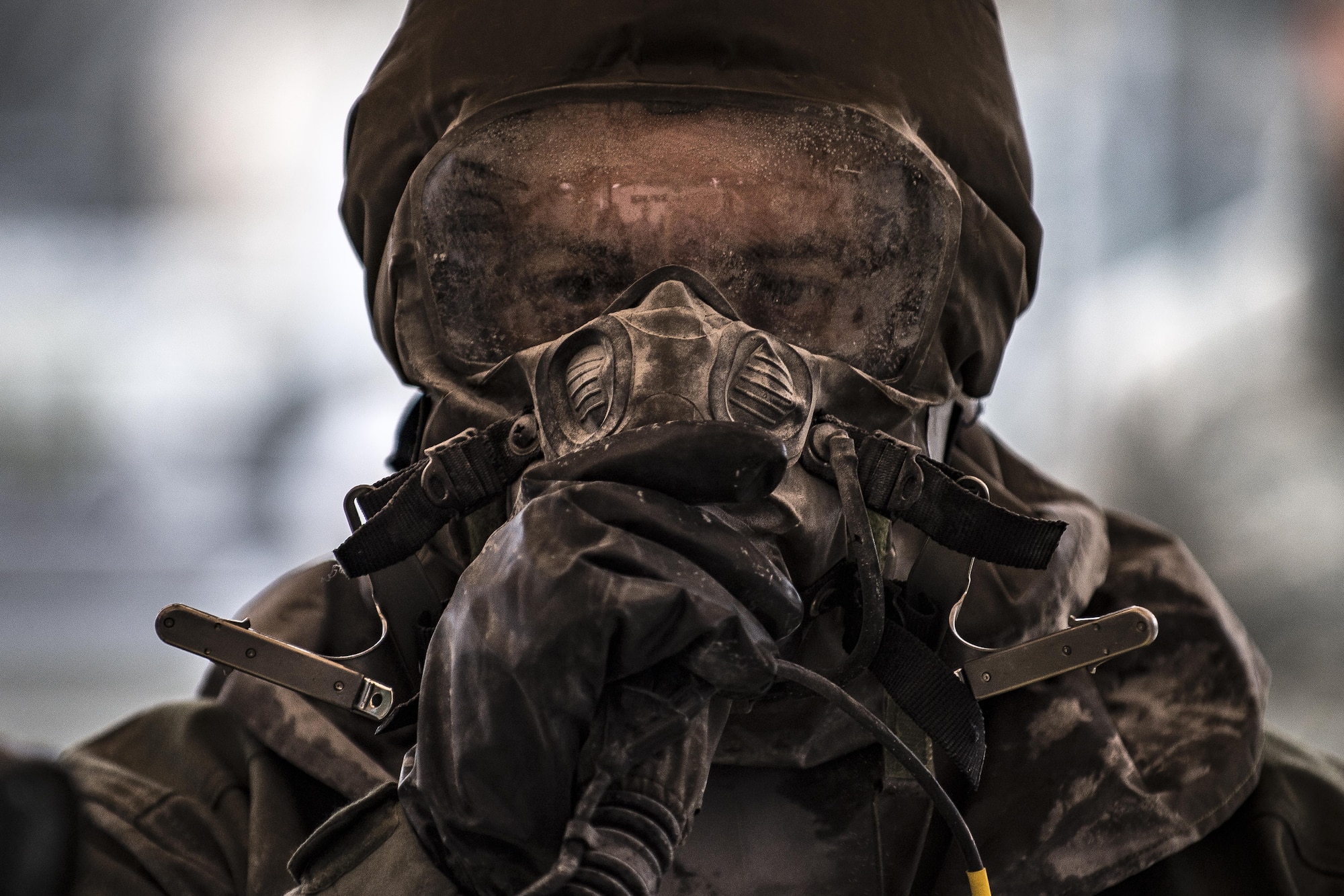 U.S. Air Force Senior Master Sgt. Bryan McCoy, Aberdeen Proving Ground Air Force Life Cycle Management Center Aircrew Flight Equipment superintendent, walks through a decontamination line during the Aircrew Contamination Mitigation course on Ramstein Air Base, Germany, Sept. 19, 2017.