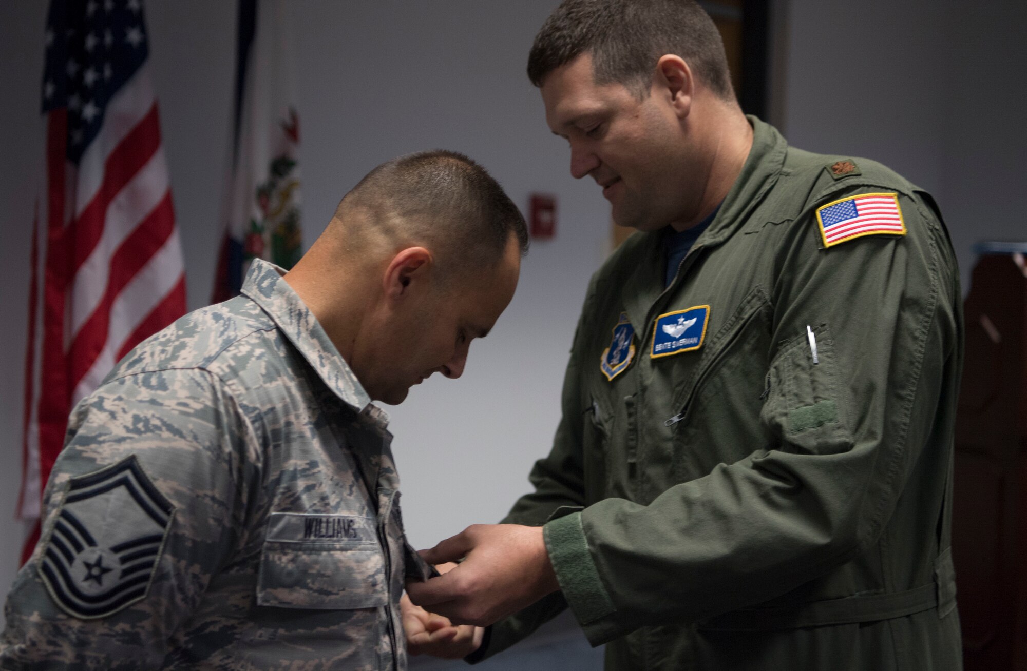 Maj. Ben Simerman pins the Military Outstanding Volunteer Service Medal on Senior Master Sgt. Kevan Williams.