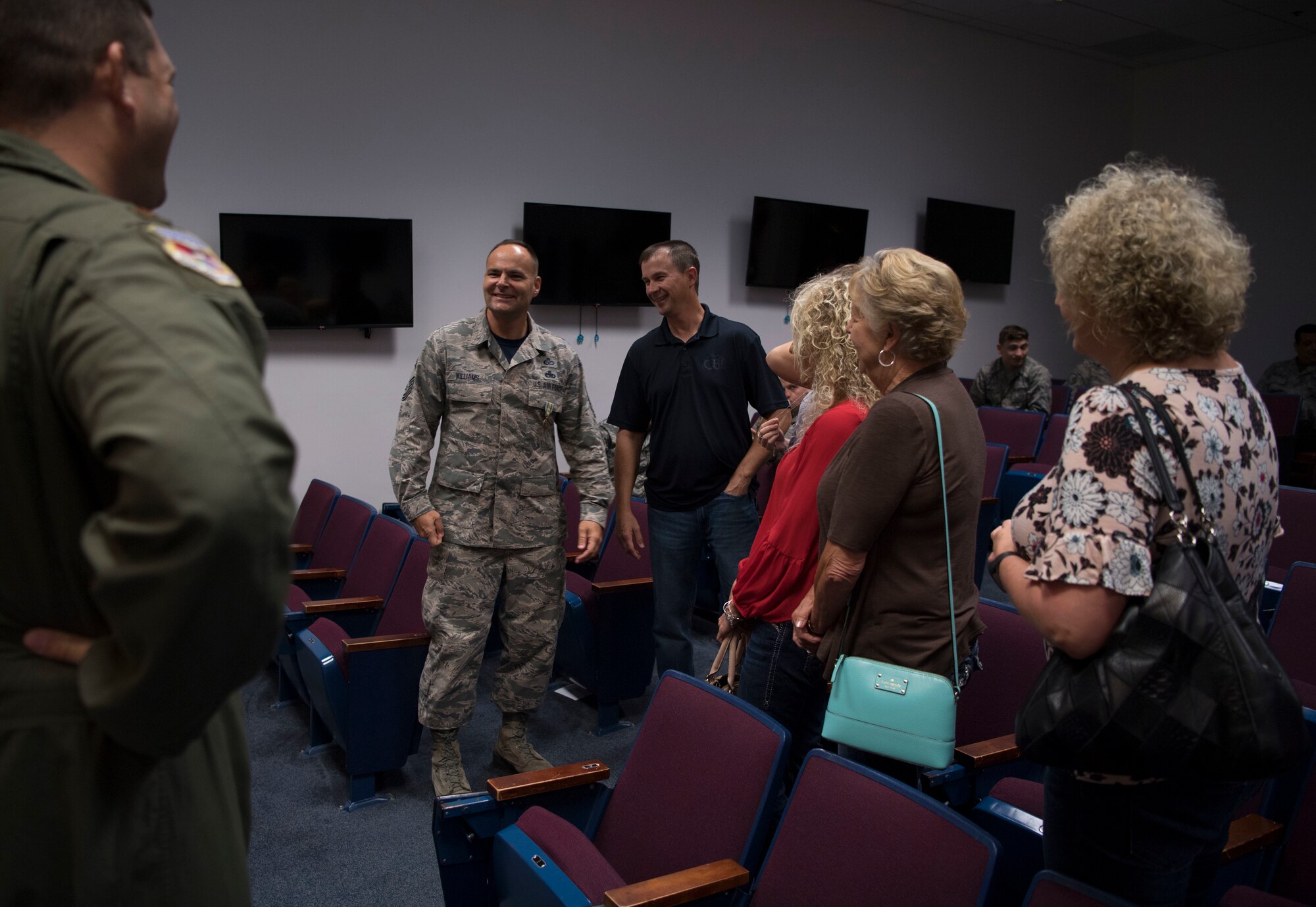 U.S. Air Force Senior Master Sgt. Kevan Williams, a safety technician with the 130th Airlift Wing, is congratulated by friends, family, and coworkers after a small ceremony where he was awarded the Military Outstanding Volunteer Service Medal Sept. 16, 2017.