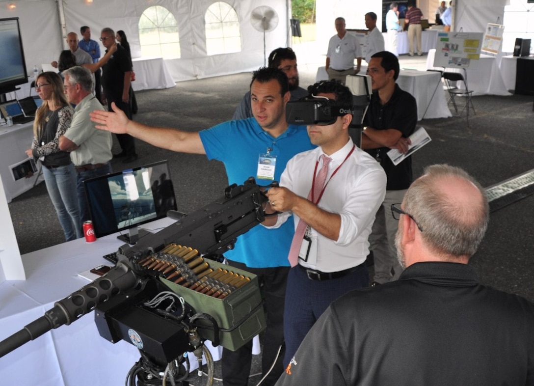 IMAGE: DAHLGREN, Va. (Sept. 14, 2017) - A visitor wearing augmented reality glasses at the 2017 Annual Navy Technology Exercise (ANTX) engages in mixed reality training 
as he fires on fast attack craft and fast inshore attack craft (FAC-FIAC) with an M-2HB .50 caliber machine gun simulator. The FAC/FIAC Integrated Training Portable
Embarkable Kit was one of many Navy Innovative Science and Engineering (NISE) funded projects on display at ANTX. The NISE FAC/FIAC project extends Fleet 
Synthetic Training to a pier-side ship for an all-inclusive self-defense training scenario against a surface swarm attack.
