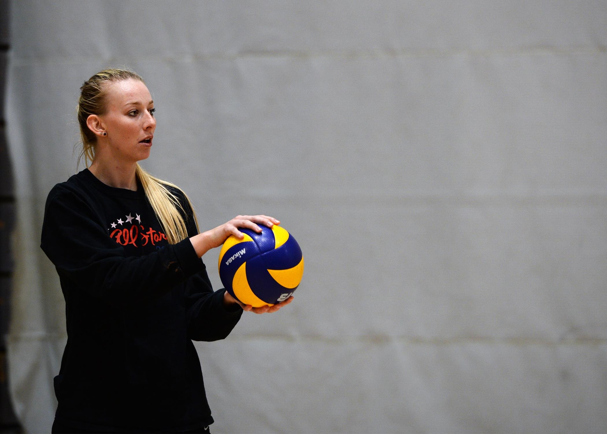Ashley Henriques, Ramstein High School Varsity Volleyball Team coach, prepares to serve the ball during tryouts at Southside Fitness Center on Ramstein Air Base, Germany, Sept. 14, 2017.