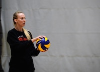 Ashley Henriques, Ramstein High School Varsity Volleyball Team coach, prepares to serve the ball during tryouts at Southside Fitness Center on Ramstein Air Base, Germany, Sept. 14, 2017.